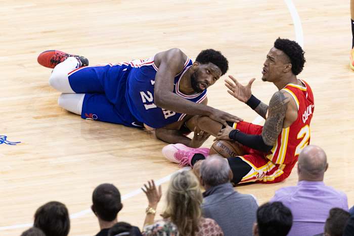 Atlanta Hawks forward John Collins (20) and Philadelphia 76ers center Joel Embiid (21) dive for the ball
